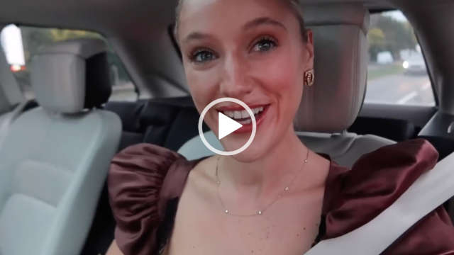 Leonora Smee rides in the back of a large SUV as she heads on a motorway into London. She wears her long blonde hair tied back in a bun. Leonora is seen in a mauve dress, gloss lipstick and black mascara. She wears a thin gold a gemstone necklace with a pair of large gold earrings.
